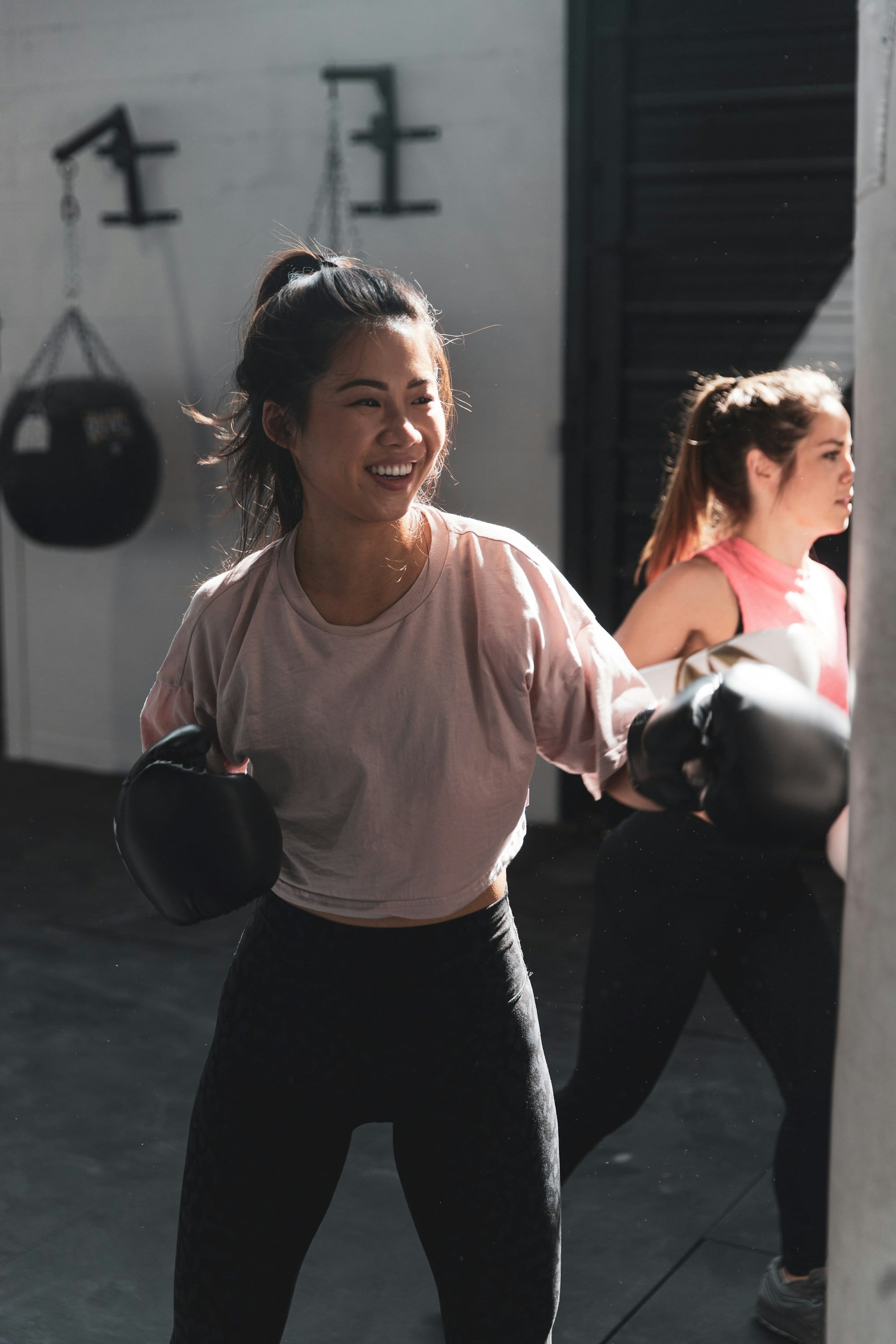 A determined individual practicing boxing techniques with gloves and a punching bag, capturing the intensity, agility, and power of a high-energy boxing workout